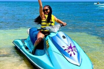Happy young Female Tourist on a Jet Ski in Jamaica with Collin's Adventure Tours