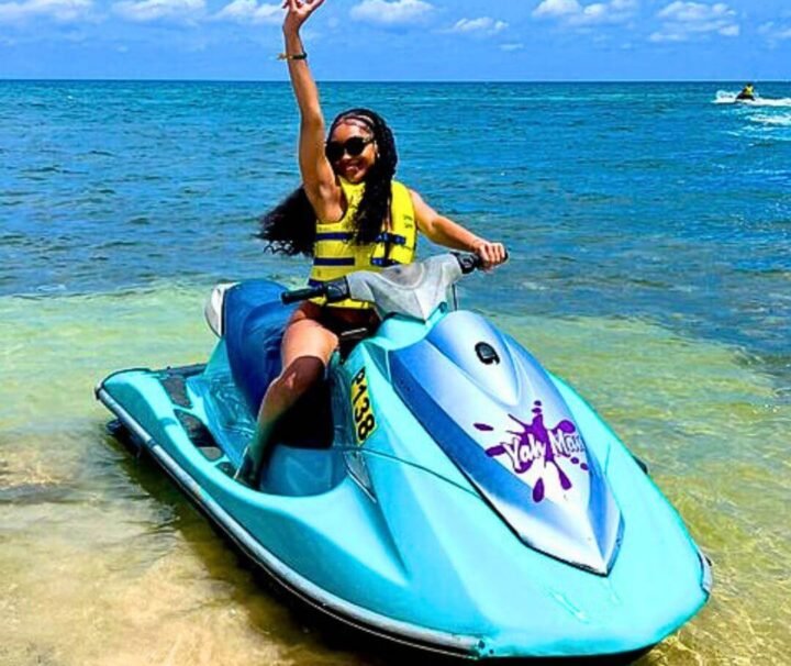 Happy young Female Tourist on a Jet Ski in Jamaica with Collin's Adventure Tours